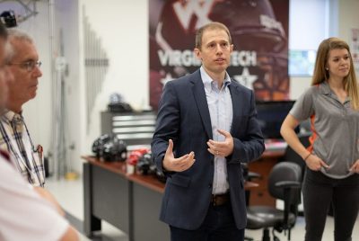 Steve Rowson greets a tour group in the Helmet Lab